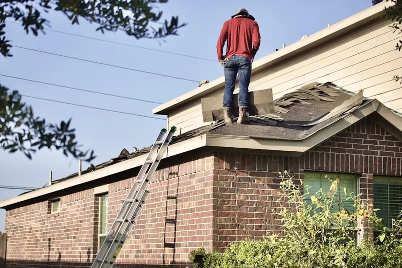 Professional roofer working on a residential roof in Litchfield Park